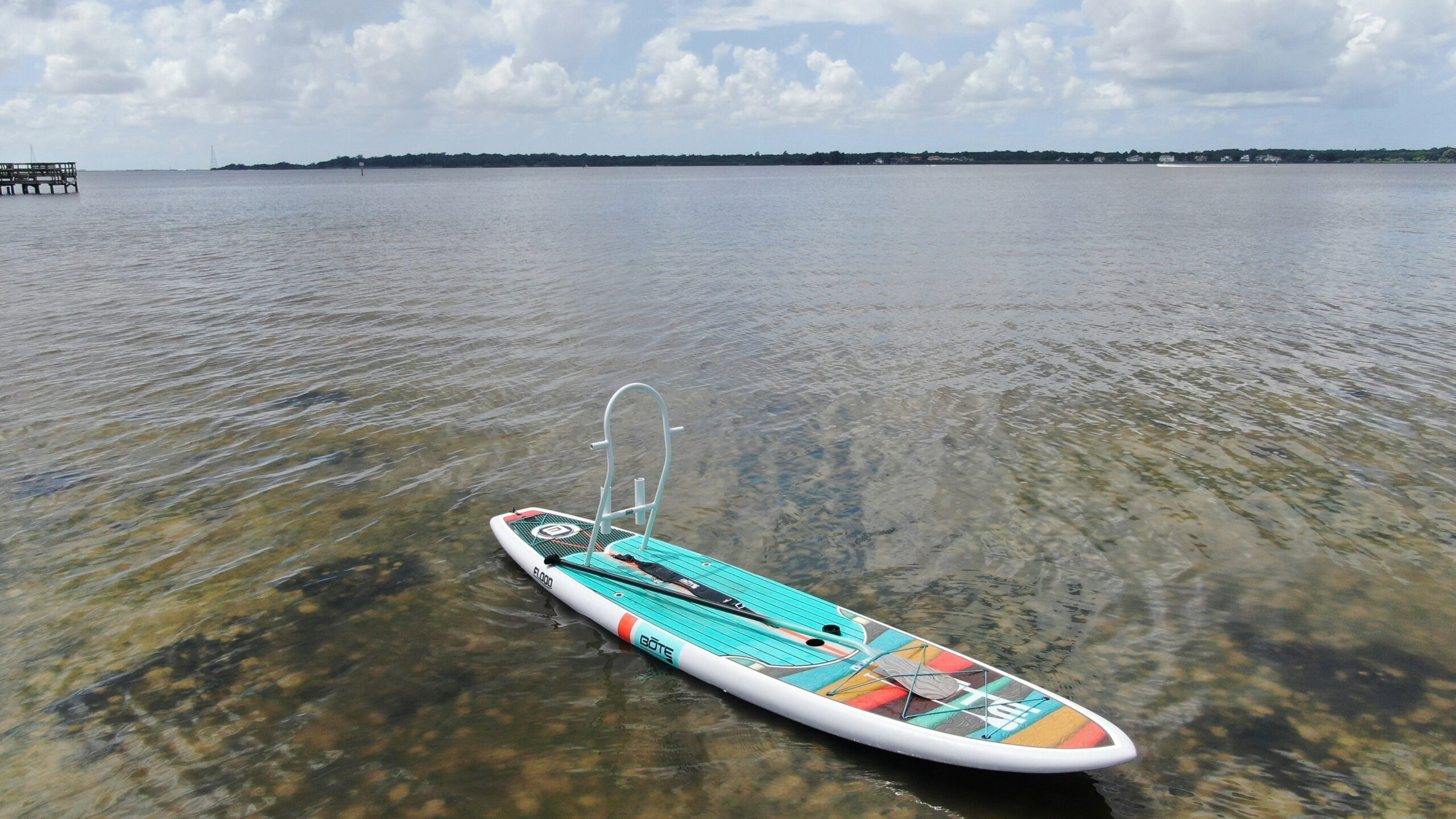 Kayaker paddling calm waters near mangrove shoreline